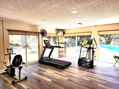 a home gym with a pool and sliding glass doors