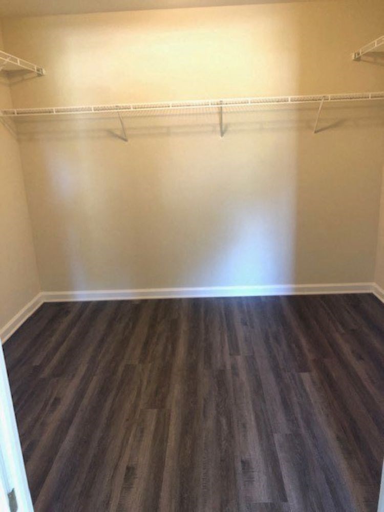 A room with a wooden floor and white walls.