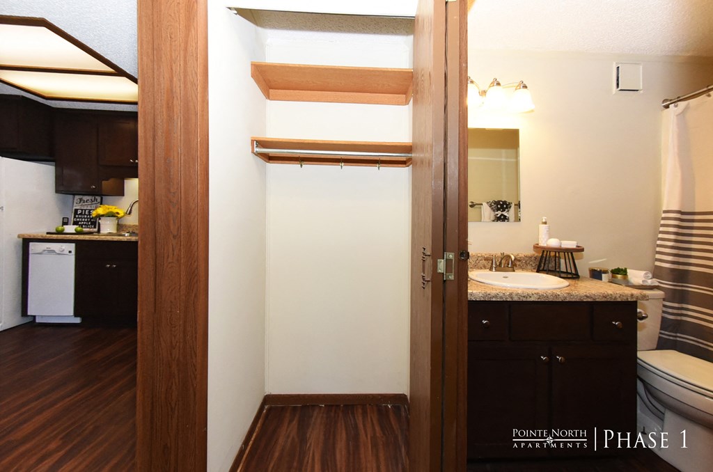 a small bathroom with a toilet and a sink in a room with a door open