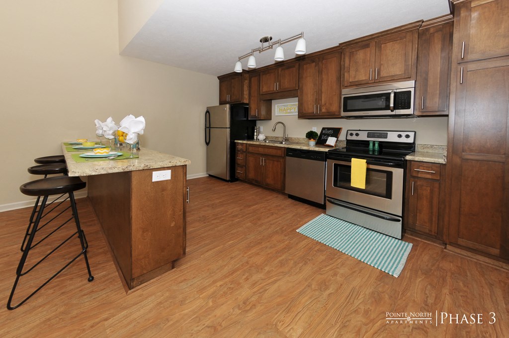 a kitchen with wooden cabinets and stainless steel appliances