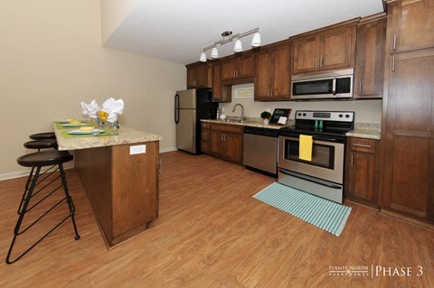 a kitchen with wooden cabinets and stainless steel appliances