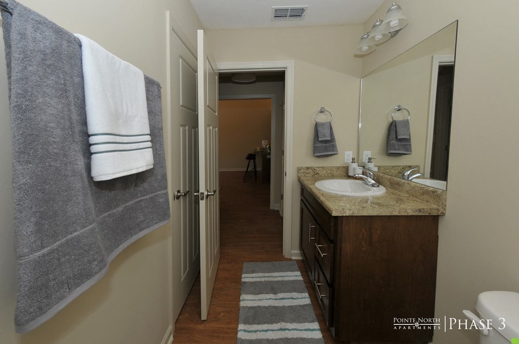 a small bathroom with a sink and a mirror and a shower