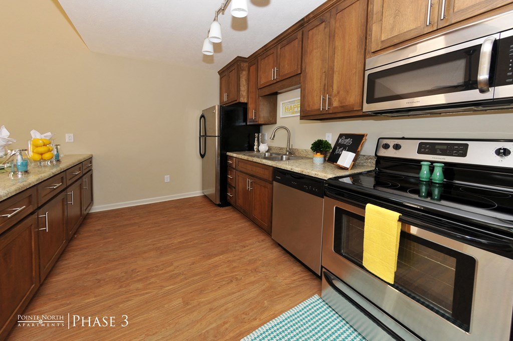 a kitchen with stainless steel appliances and wooden cabinets