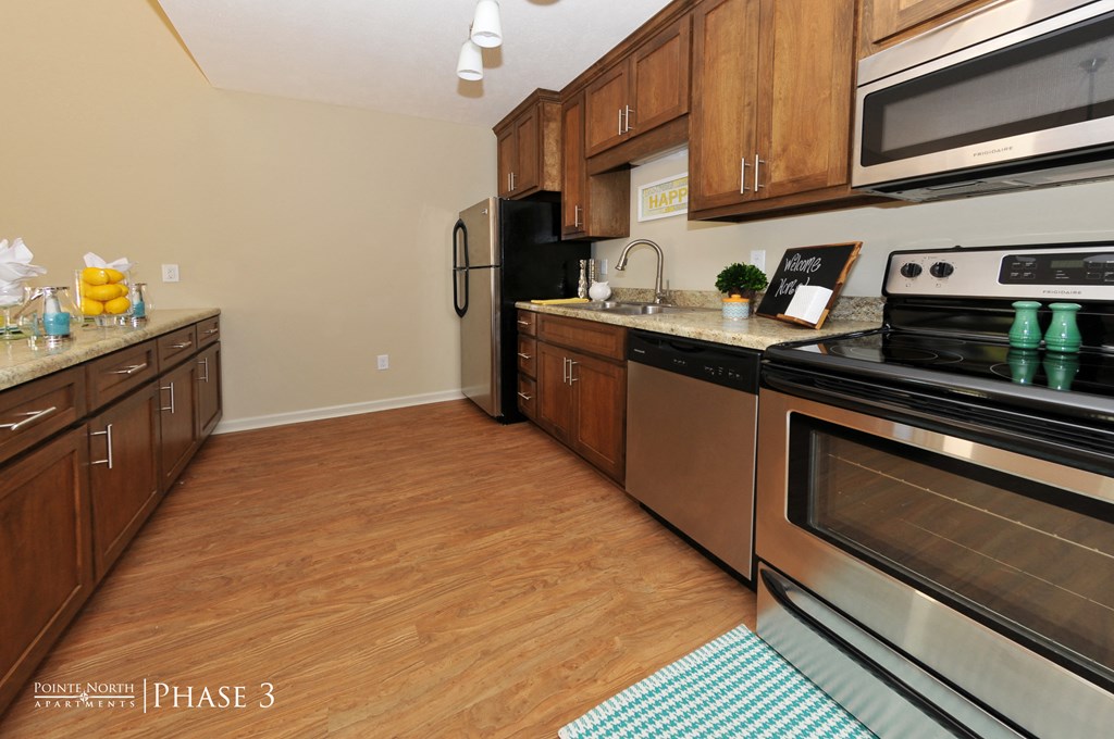 a kitchen with stainless steel appliances and wooden cabinets