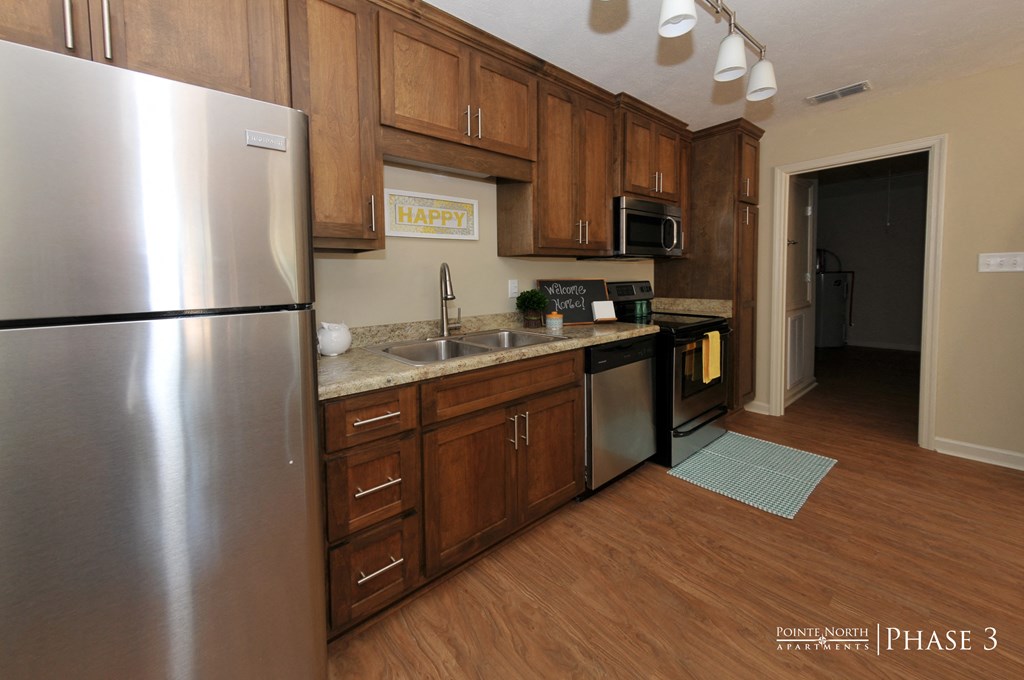 a kitchen with stainless steel appliances and wooden cabinets