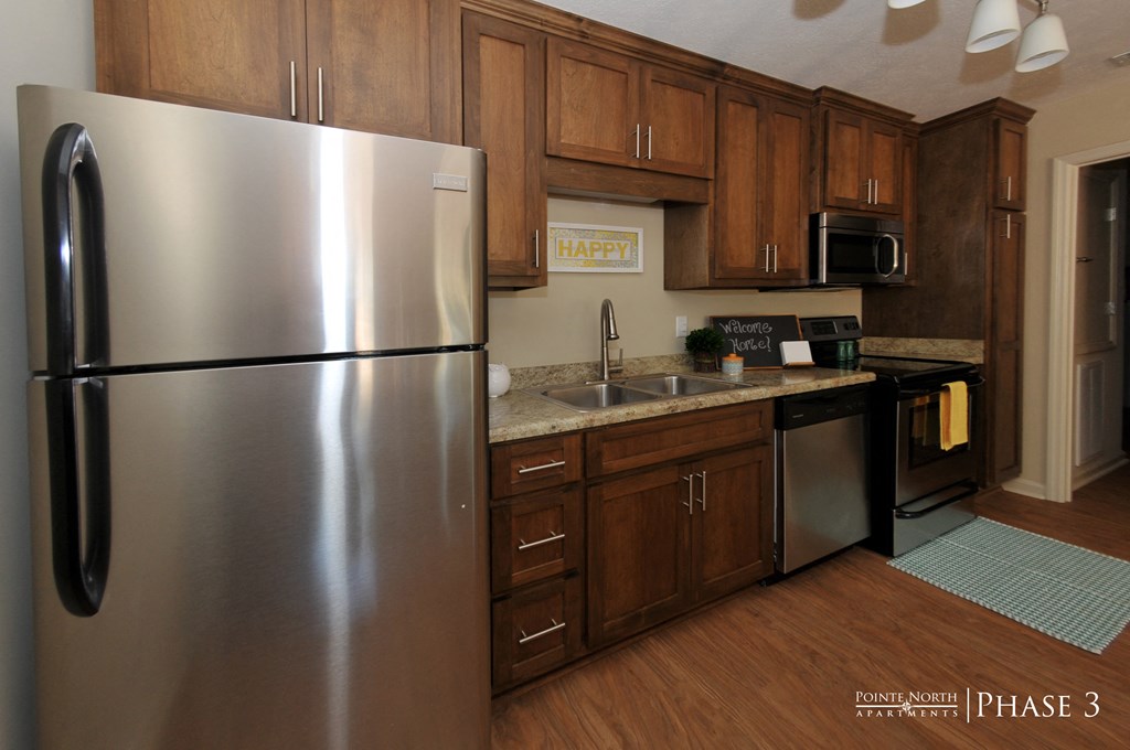 a kitchen with stainless steel appliances and wooden cabinets