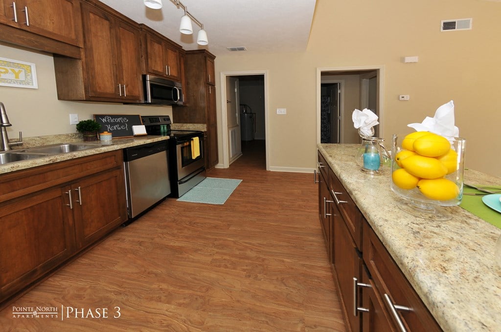 a kitchen with wooden cabinets and a counter top with lemons