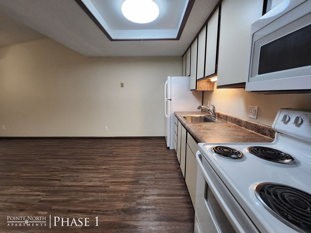 a kitchen with white appliances and a white stove top oven