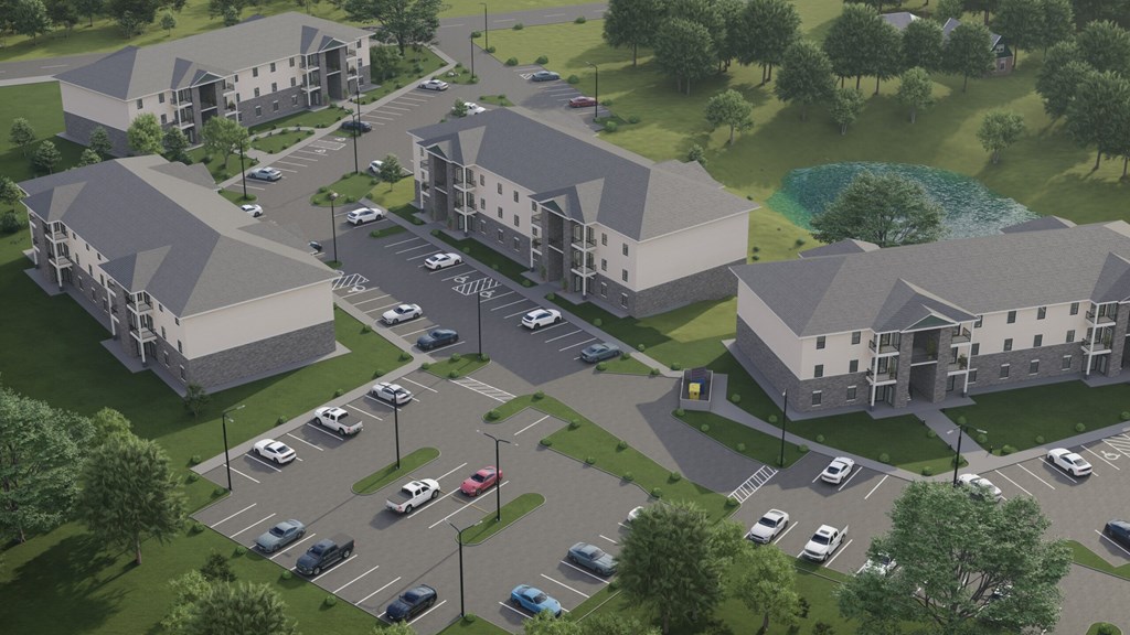 A rendering of a residential complex with a parking lot in front.