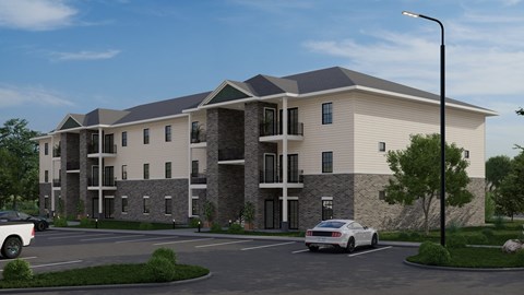A modern apartment building with a parking lot in front.