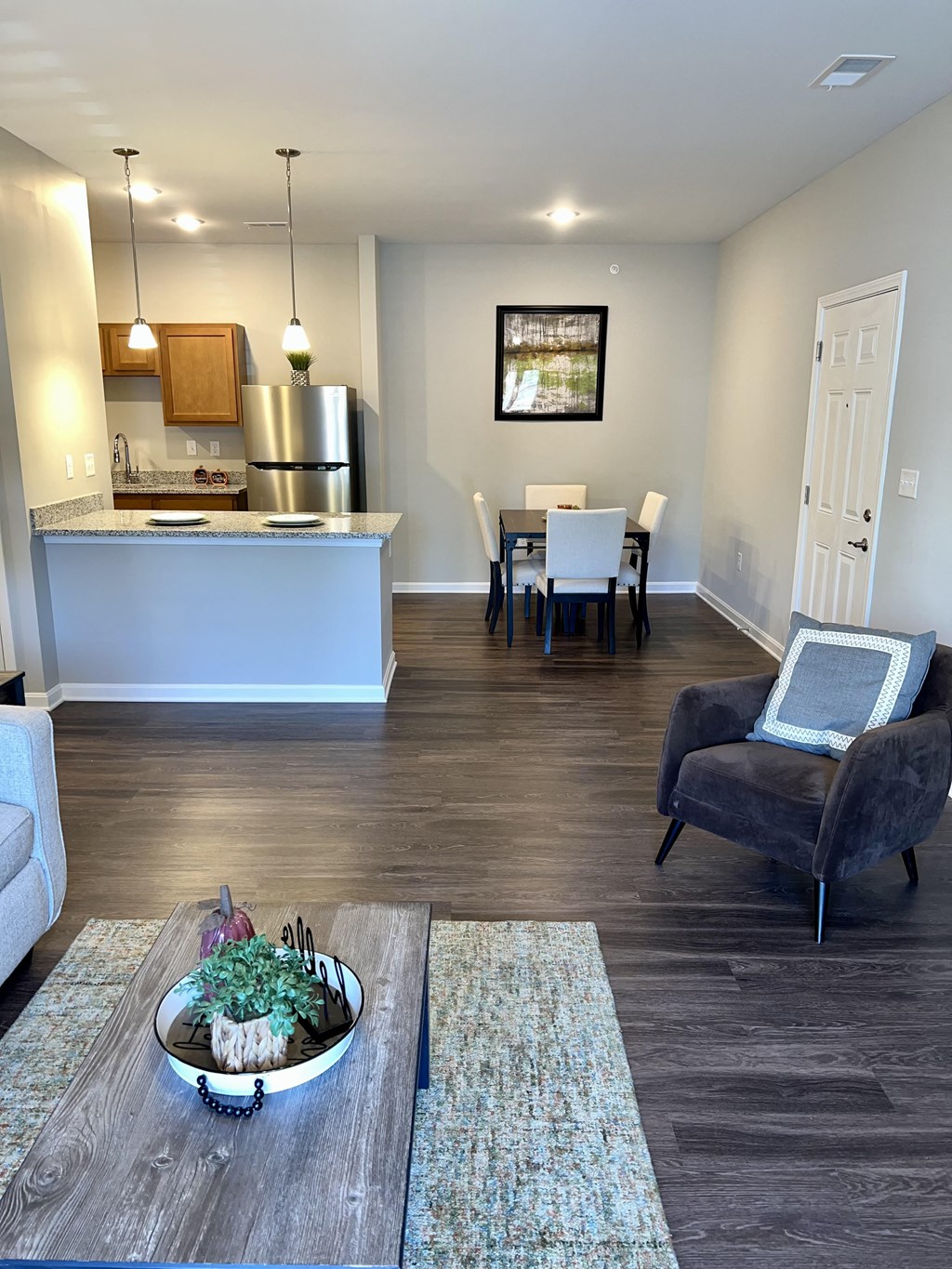 a living room and dining room with a table and a kitchen