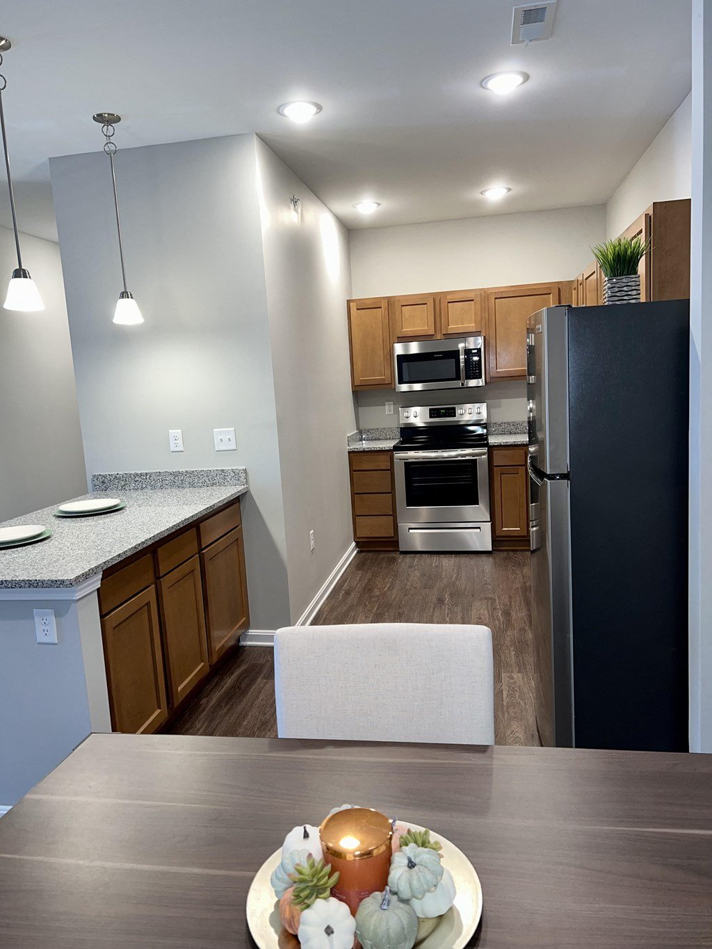 the 2 bedroom kitchen with stainless steel appliances and model furniture