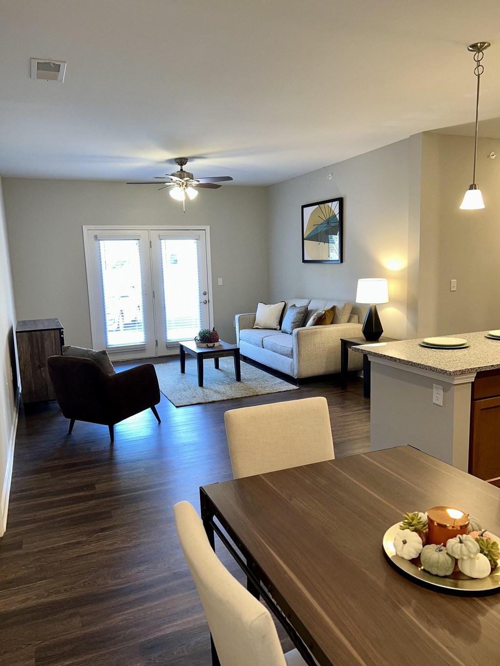a view of a living room and dining room from the kitchen of an apartment