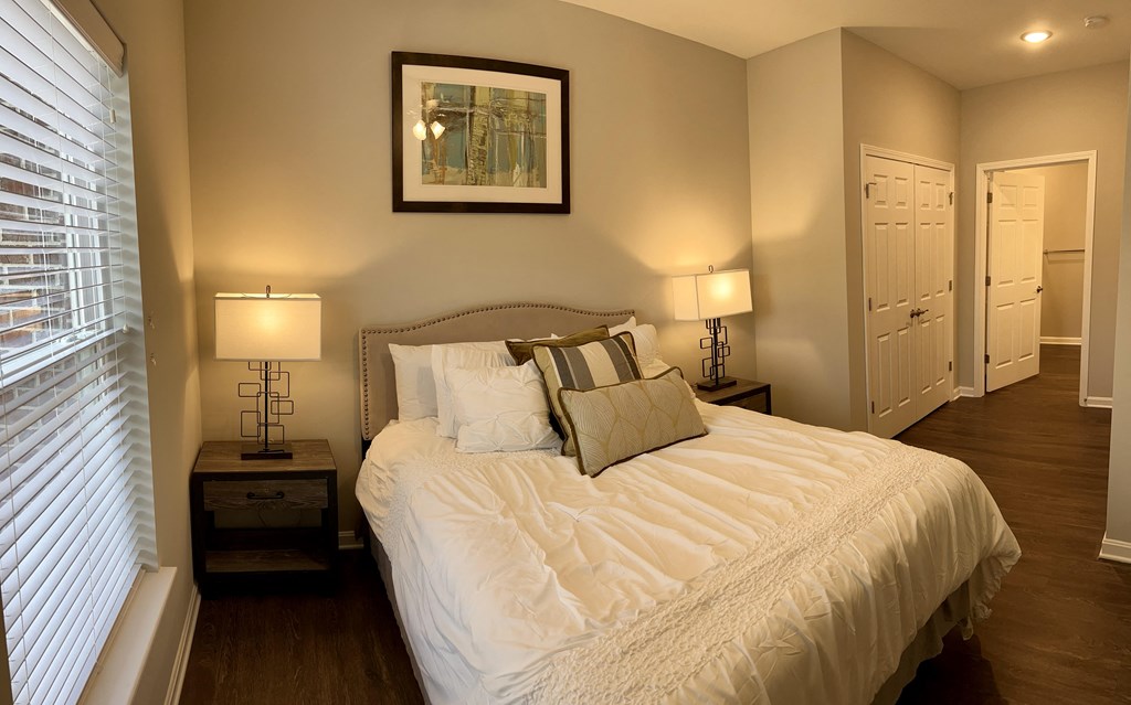 a bedroom with a large bed and a window