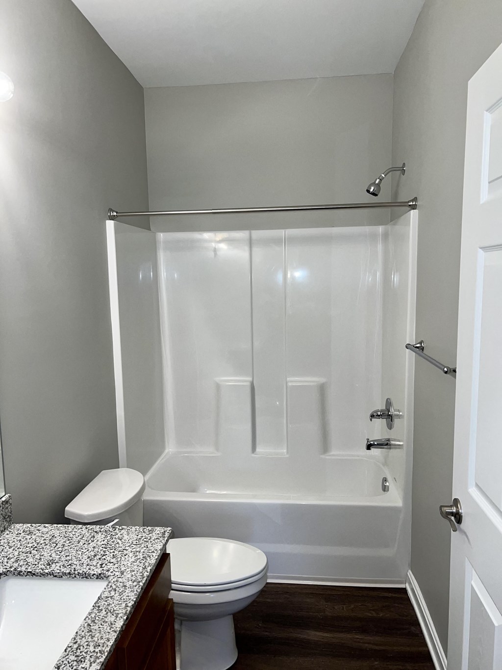 a small bathroom with a shower toilet and sink
