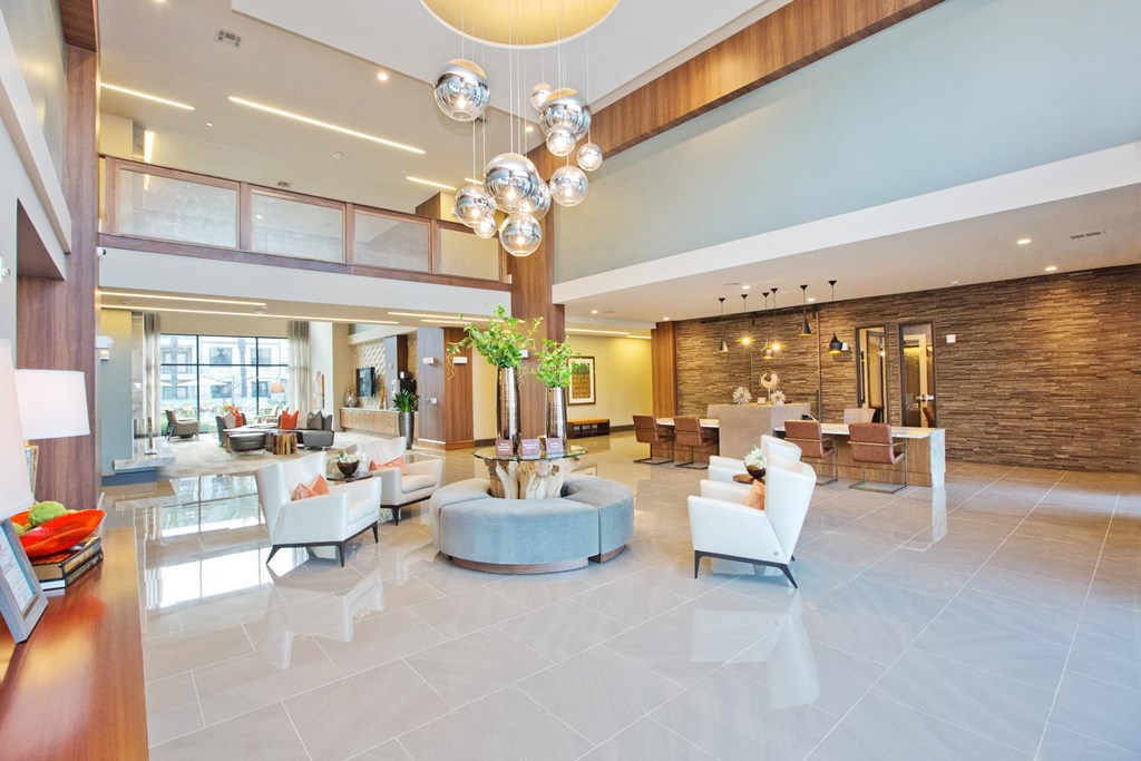 a lobby of a hotel with couches and chairs