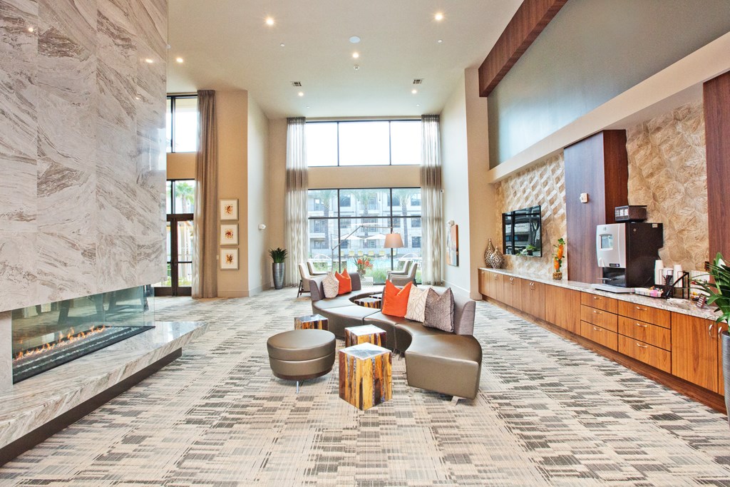 a large living room with a fireplace and couches