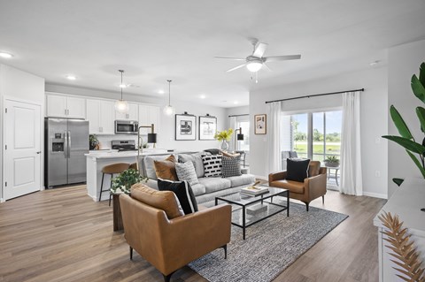 A modern living room with a brown leather sofa and a glass coffee table.