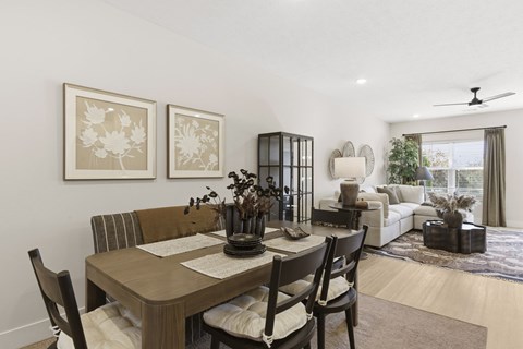 A dining room with a wooden table and chairs.