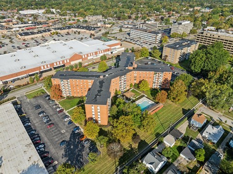 A large building complex with a parking lot in front.