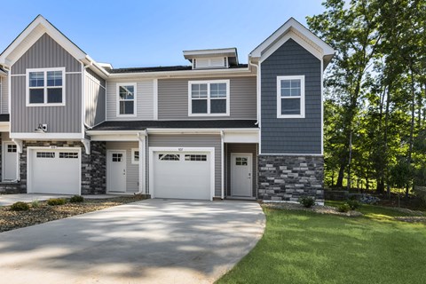 A modern two-story house with a garage.