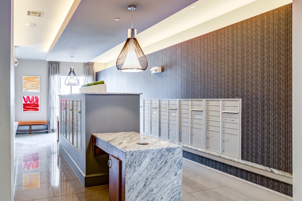 a long counter in a room with mailboxes and a desk