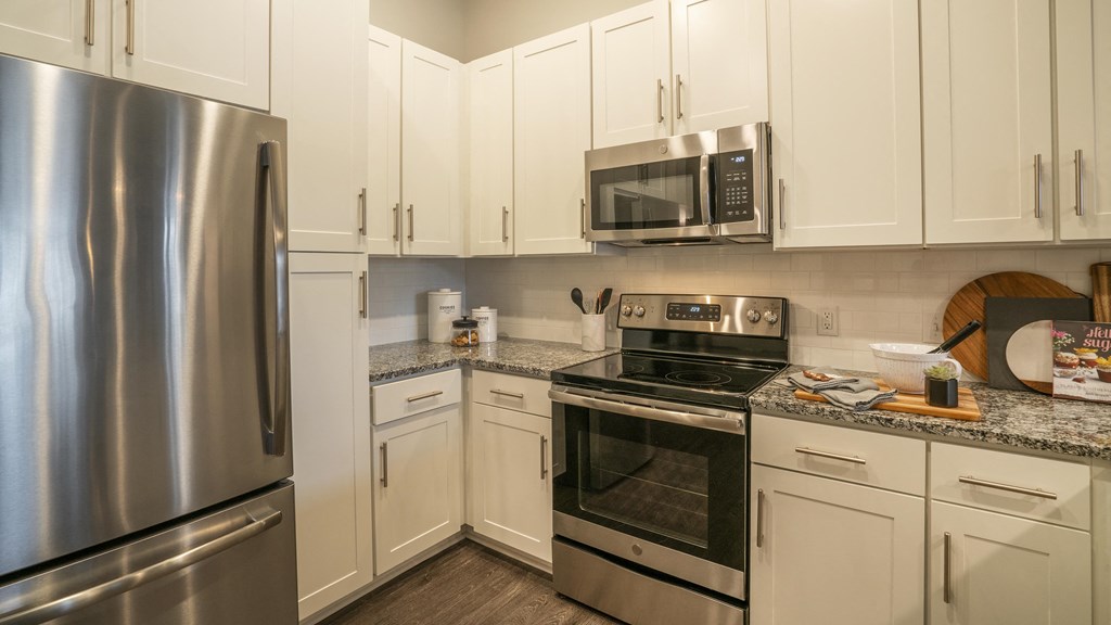 a kitchen with stainless steel appliances and white cabinets
