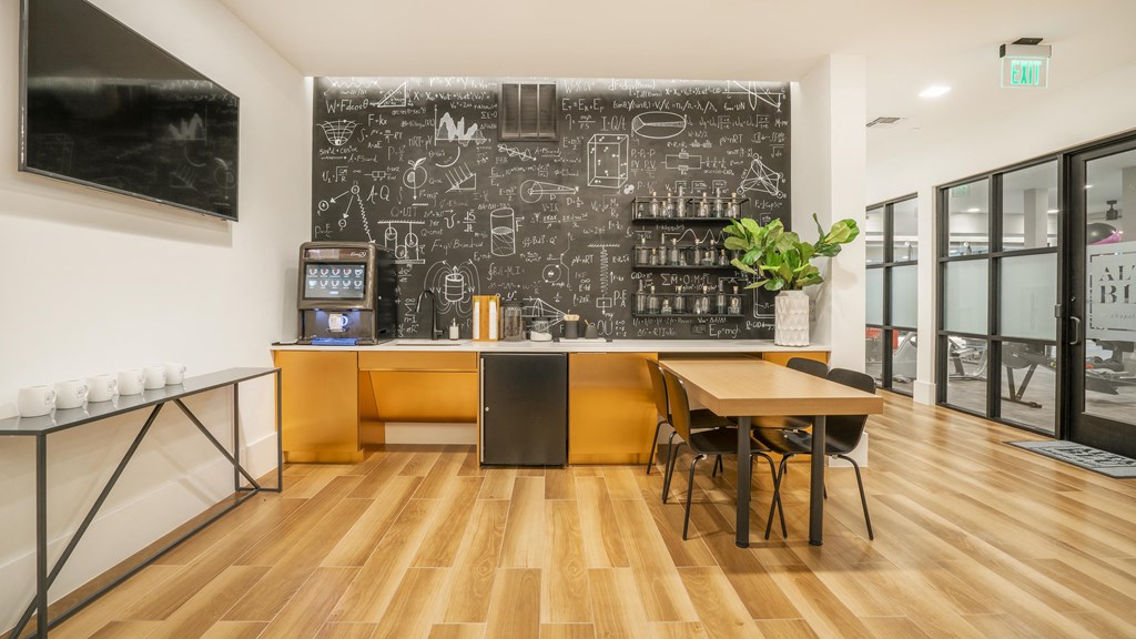 a chalkboard wall in a dining room with a table and chairs
