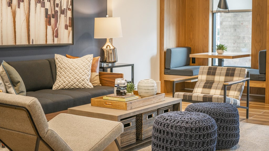 a living room with a couch and chairs and a coffee table