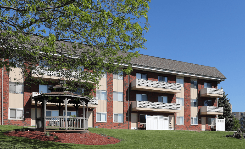 A large apartment building with a gazebo in front.
