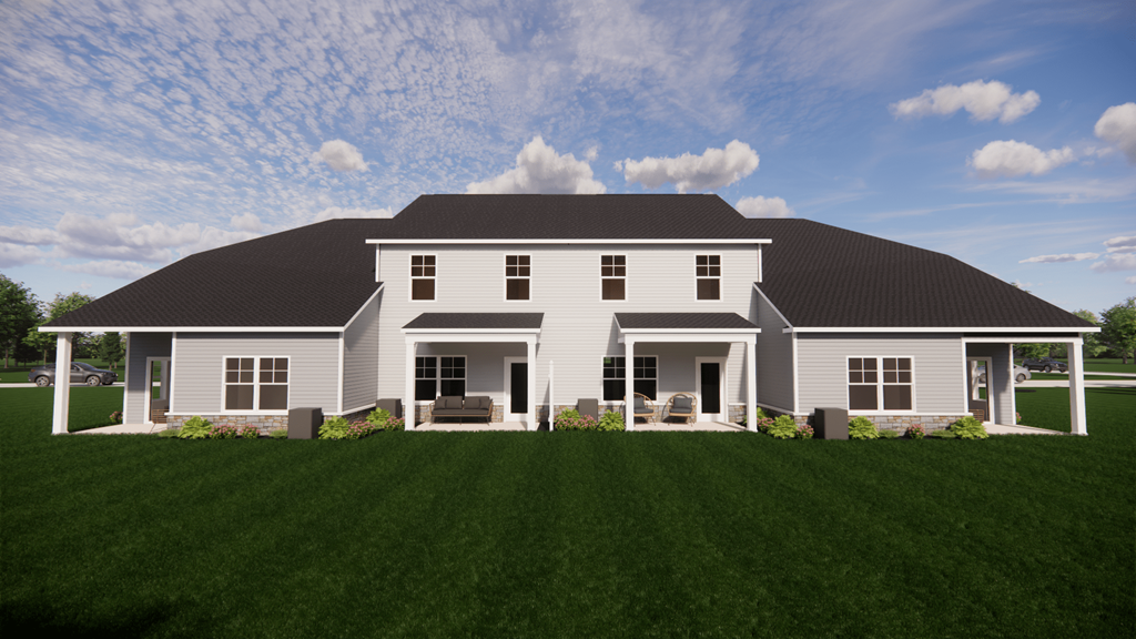 A large white house with a black roof and a covered porch.