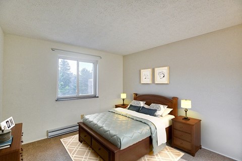 A bedroom with a bed, nightstand, and window.