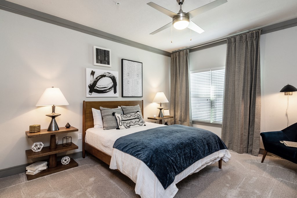 a bedroom with a bed and a ceiling fan