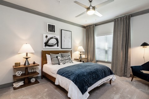 a bedroom with a bed and a ceiling fan