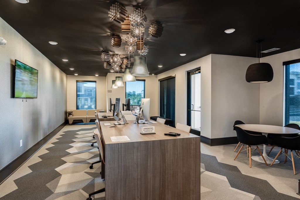 a conference room with a table and chairs and a desk