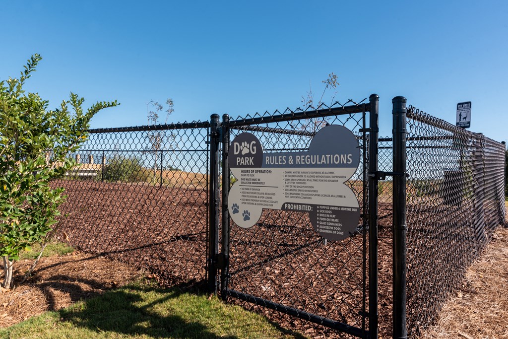 a gate with a sign on it in front of a fence