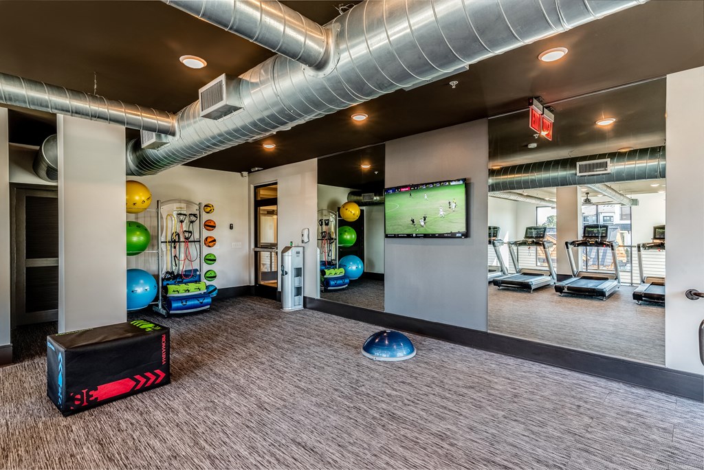 the gym at the flats at obsidiancontinued furnished area with exercise equipment