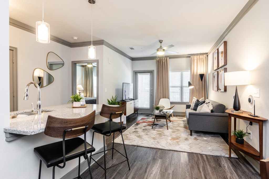 a living room and dining room with a table and chairs