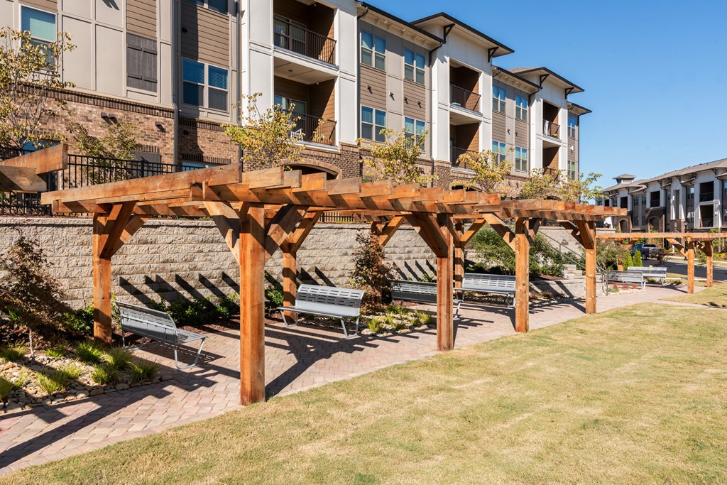 a picnic area with benches in front of an apartment building