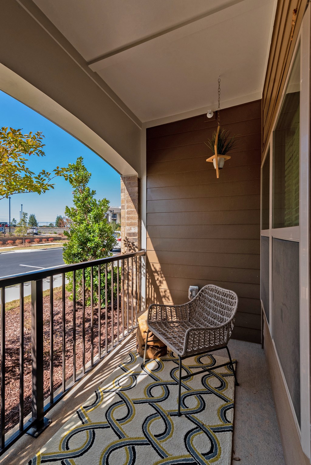 a porch with a chair and a view of the street