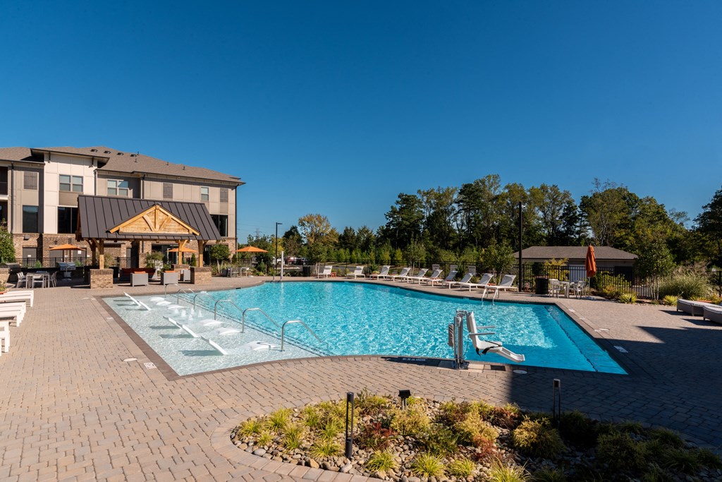 a swimming pool with a hotel in the background