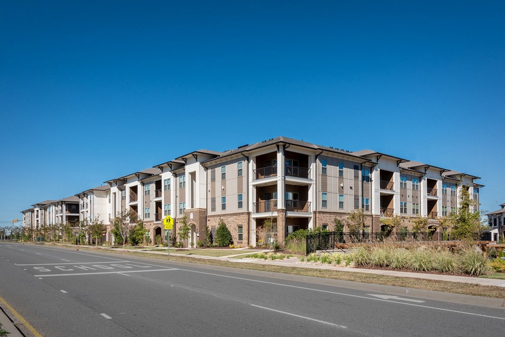 a row of apartment buildings on the side of a street