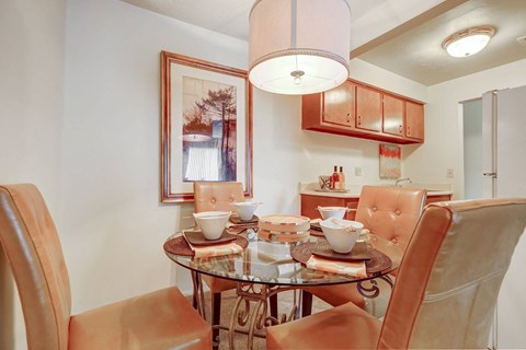 a dining room table with chairs and a chandelier
