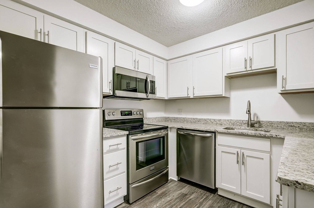 a kitchen with stainless steel appliances and white cabinets