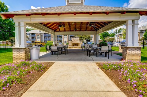A covered patio area with a table and chairs.