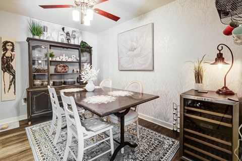 A dining room with a table and chairs.