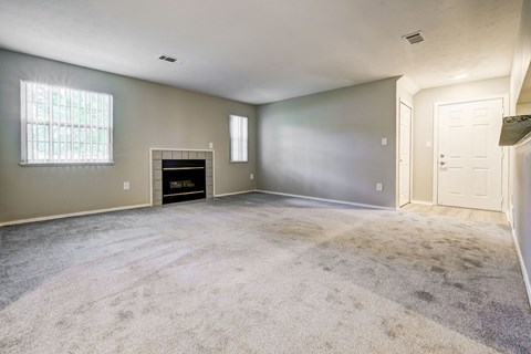 A room with a fireplace and a window.