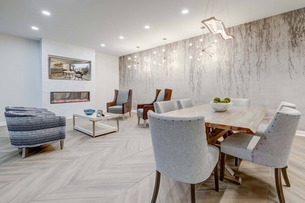 a dining room with a wooden table and chairs and a fireplace