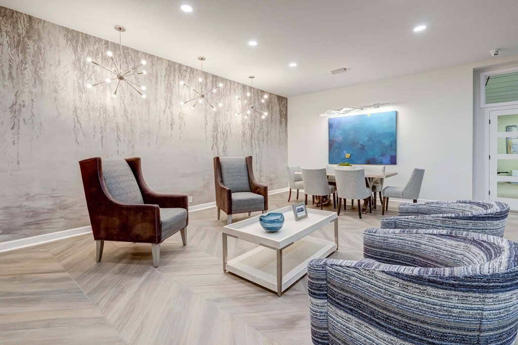 a living room with a couch and chairs and a table