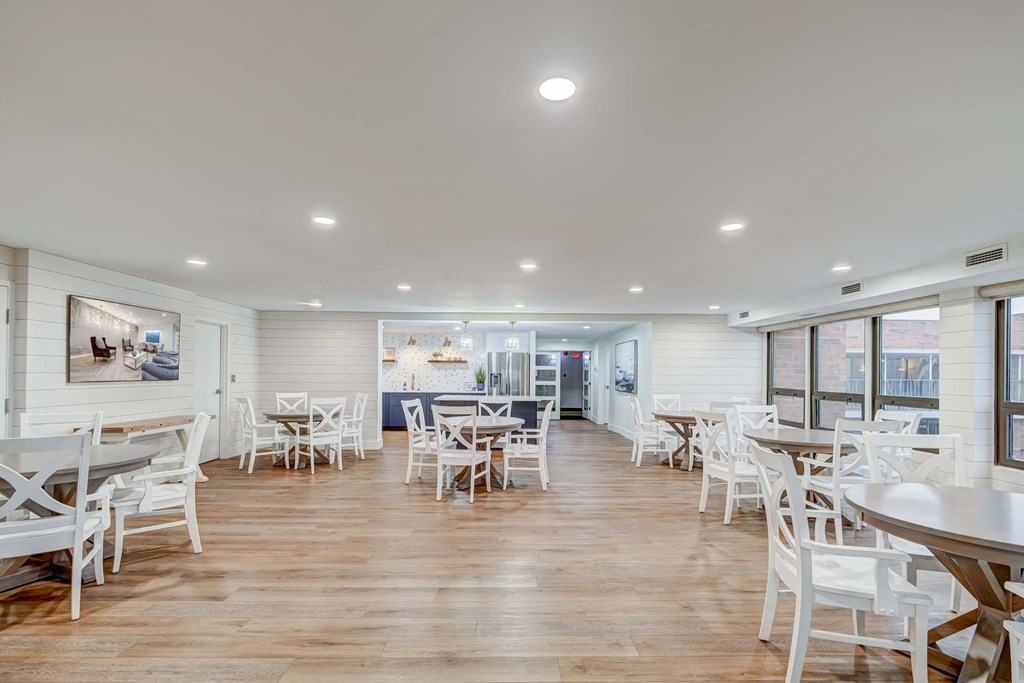 a dining room with tables and chairs and windows